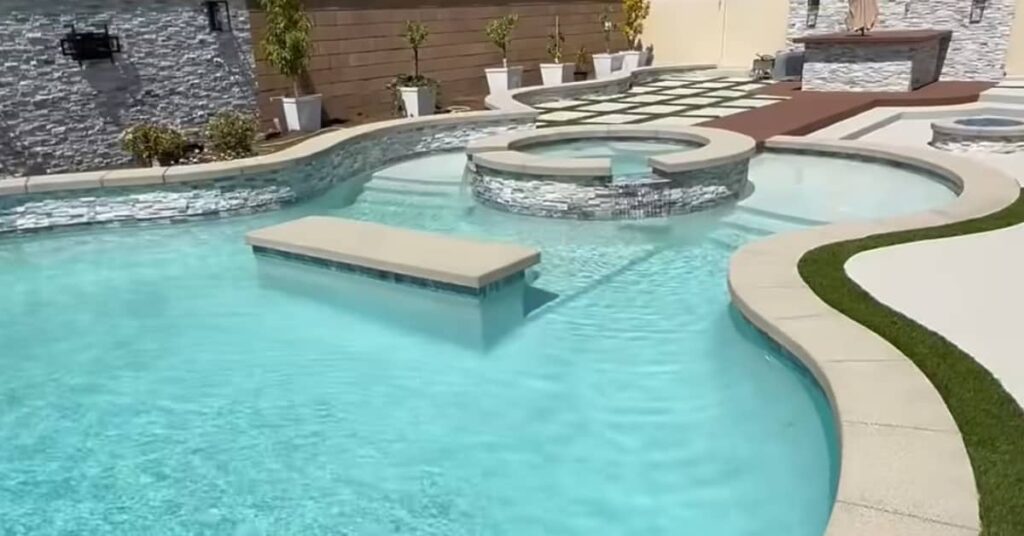 pool and spa with salt and pepper mini pebble pool finish