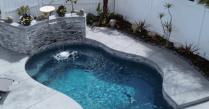 pool, stone waterfall, by Majestic Pool Construction in his blog, When Is the Best Time to Start Building a Pool in Southern California?